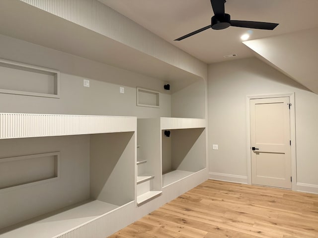 additional living space featuring ceiling fan and light hardwood / wood-style flooring