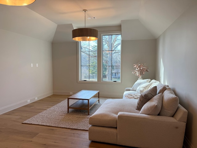 living room with lofted ceiling and hardwood / wood-style floors