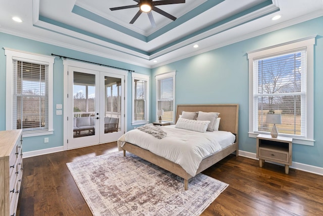 bedroom featuring access to exterior, dark wood finished floors, french doors, and a tray ceiling