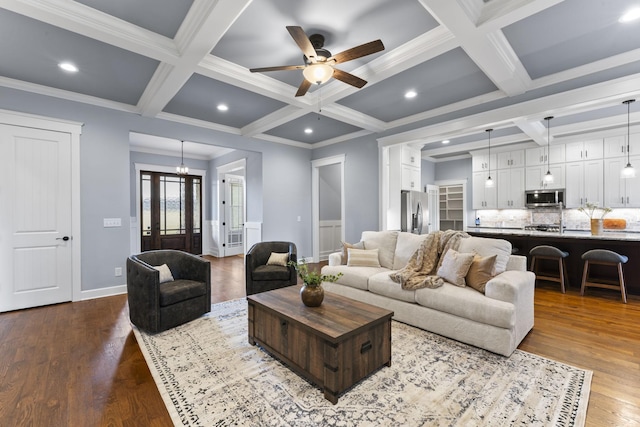 living room with beam ceiling, coffered ceiling, and dark wood finished floors