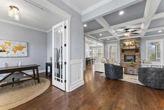 interior space with crown molding, beamed ceiling, wood finished floors, and coffered ceiling