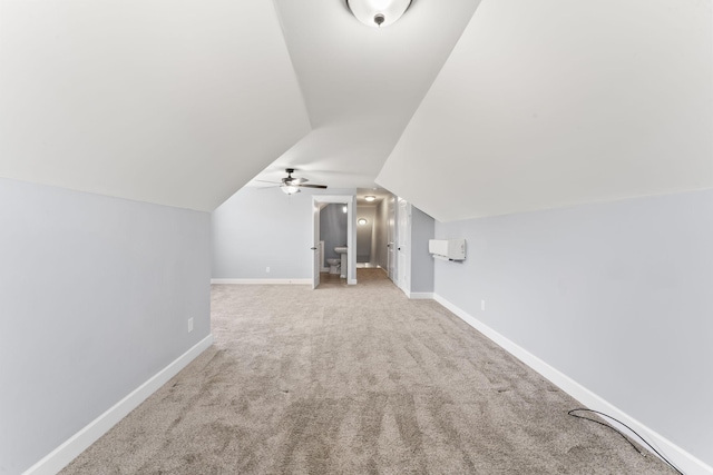 additional living space with baseboards, carpet floors, and vaulted ceiling