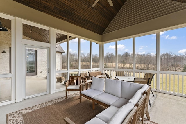 sunroom / solarium featuring ceiling fan, lofted ceiling, and wooden ceiling
