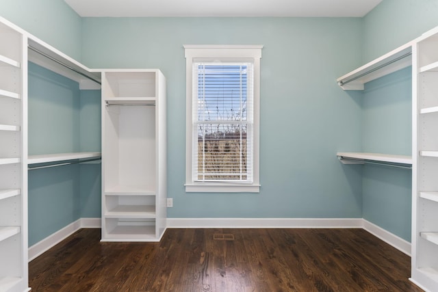 spacious closet featuring visible vents and wood finished floors