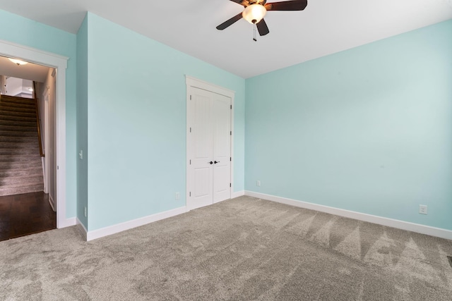 interior space featuring stairway, a ceiling fan, and baseboards
