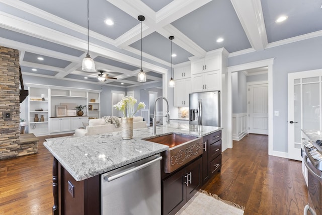 kitchen featuring beamed ceiling, dark wood-style floors, appliances with stainless steel finishes, and a sink
