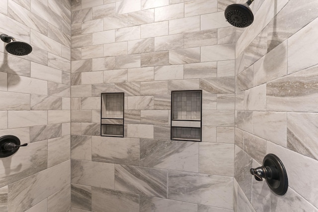 interior details featuring tiled shower