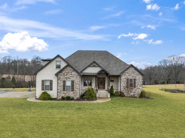 view of front of house featuring a front lawn and a shingled roof