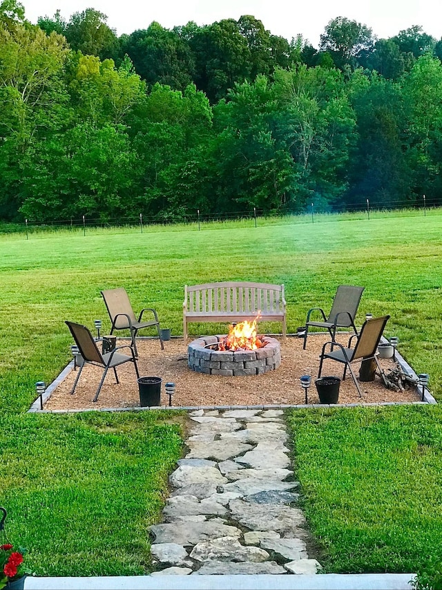 view of yard with a fire pit