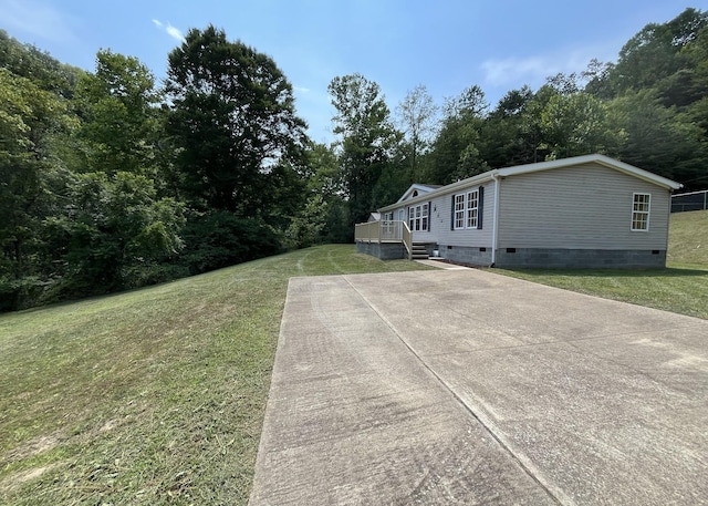 view of side of home featuring crawl space and a yard