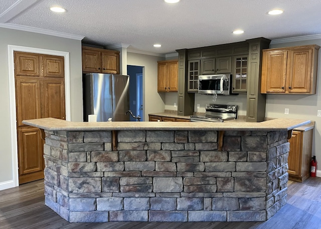 kitchen featuring stainless steel appliances, glass insert cabinets, dark wood-style floors, and crown molding