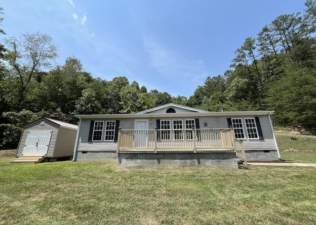 view of front of house featuring a front yard, an outdoor structure, a shed, and crawl space