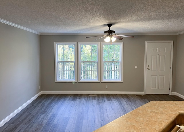 interior space featuring dark wood finished floors, a healthy amount of sunlight, and ornamental molding