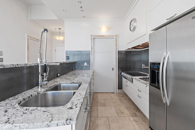 kitchen featuring stainless steel refrigerator with ice dispenser, sink, white cabinets, pendant lighting, and backsplash