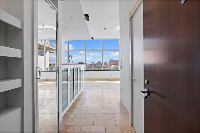 hallway with light tile patterned flooring and a wealth of natural light