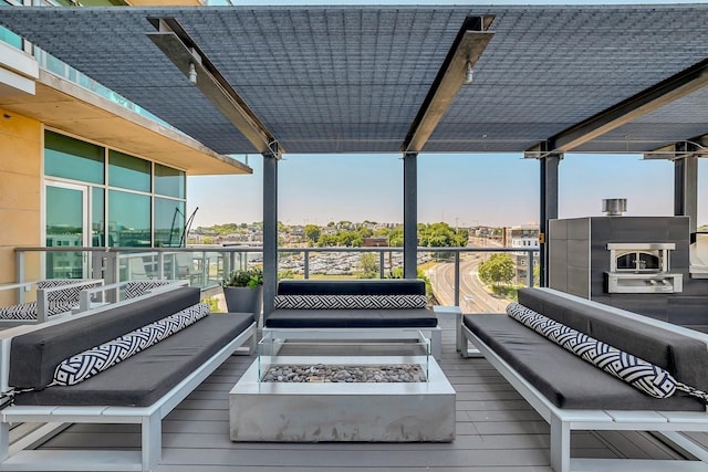 deck with an outdoor living space with a fire pit