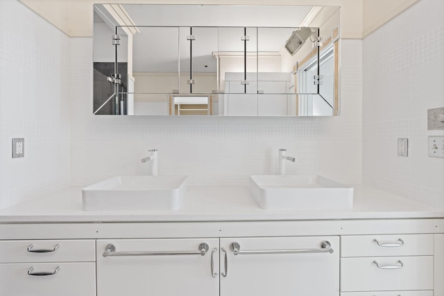 bathroom with tasteful backsplash, vanity, and tile walls