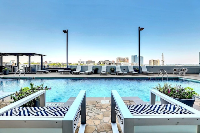 view of swimming pool with a patio area and a pergola