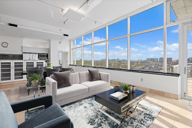 tiled living room featuring rail lighting