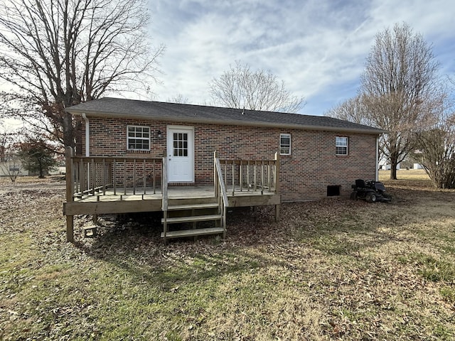 back of house featuring a deck and a lawn