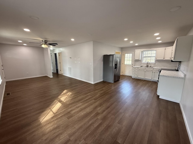 kitchen featuring ceiling fan, white cabinetry, dark hardwood / wood-style floors, stainless steel refrigerator with ice dispenser, and light stone countertops