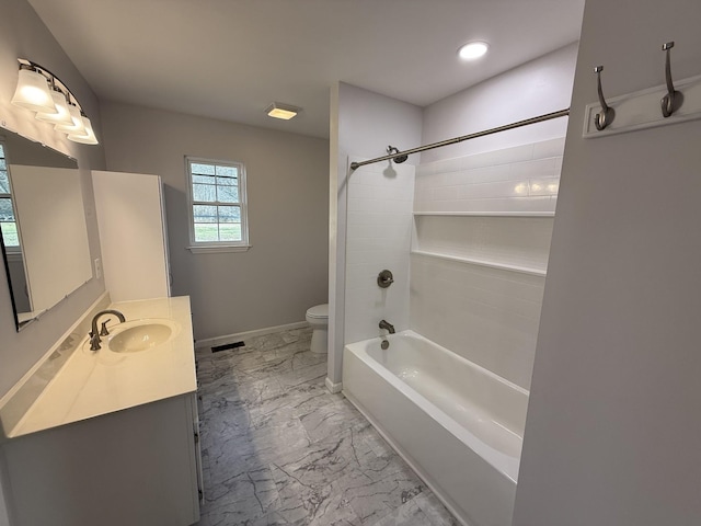 full bathroom featuring vanity, tiled shower / bath, and toilet