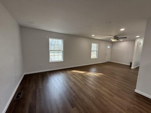 spare room featuring ceiling fan and dark hardwood / wood-style flooring