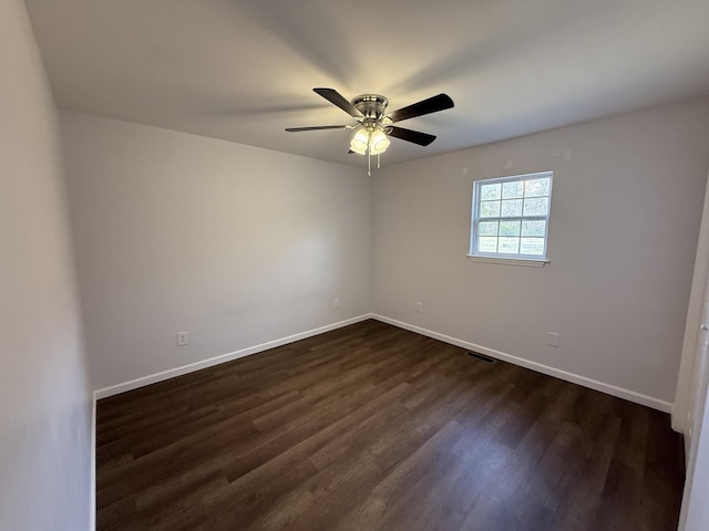 empty room featuring ceiling fan and dark hardwood / wood-style flooring