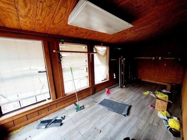 exercise room with wood ceiling, wood-type flooring, and wood walls