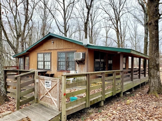 view of outdoor structure with an AC wall unit