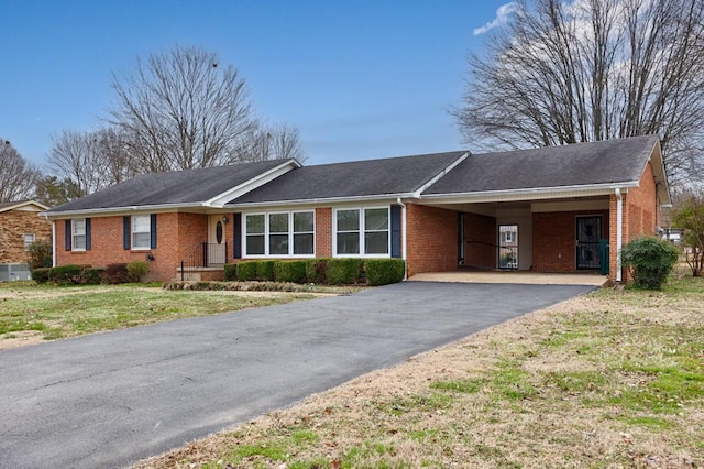 single story home with a front yard and a carport