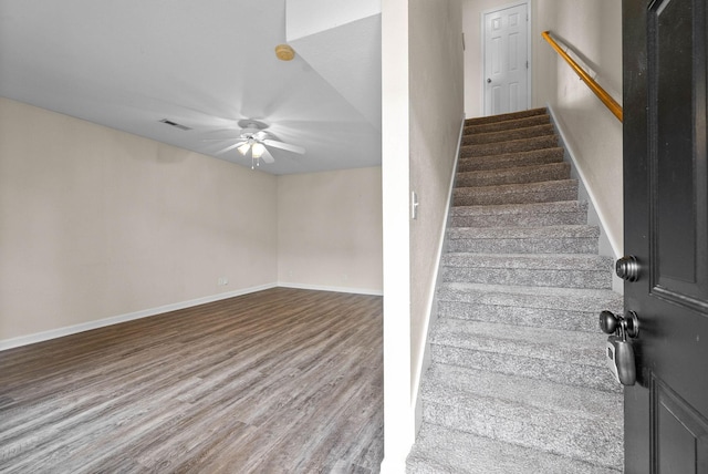 stairs featuring hardwood / wood-style floors