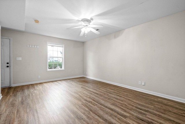 unfurnished room featuring ceiling fan and dark hardwood / wood-style flooring