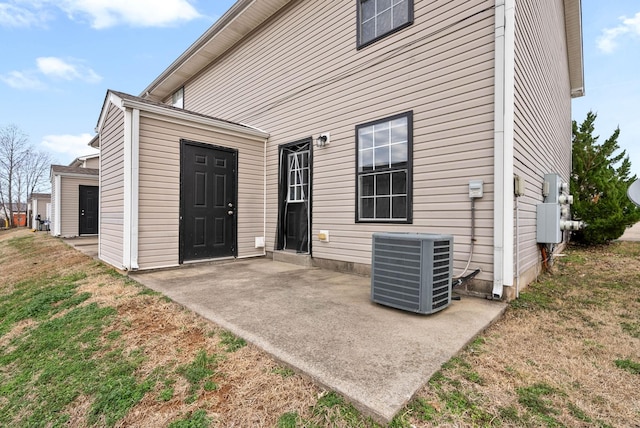 exterior space featuring central AC, a patio, and a lawn