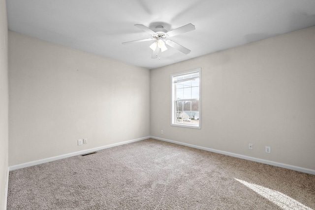 empty room featuring ceiling fan and carpet flooring