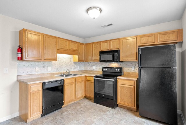 kitchen featuring backsplash, sink, and black appliances