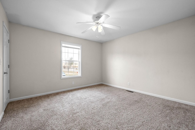 carpeted empty room featuring ceiling fan