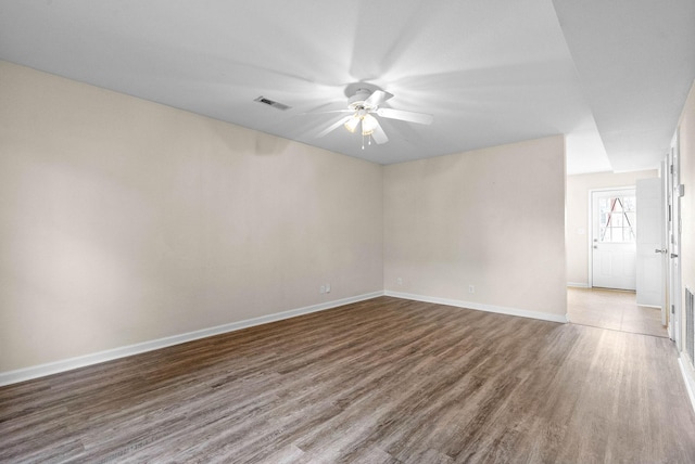 empty room with hardwood / wood-style flooring and ceiling fan