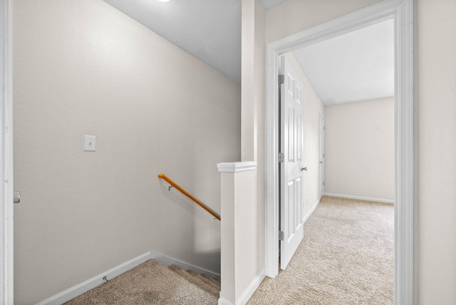 hallway featuring light colored carpet