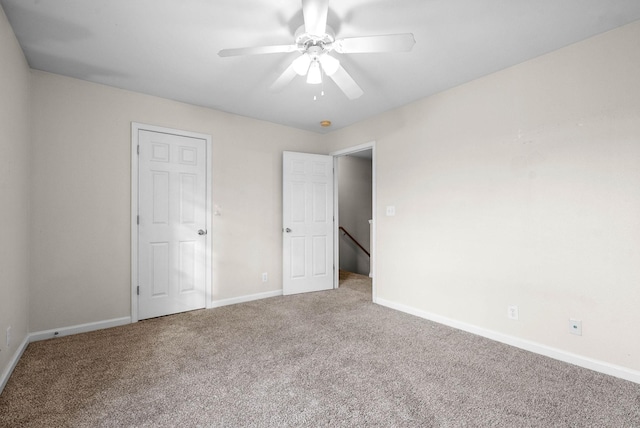 unfurnished bedroom featuring ceiling fan and carpet flooring