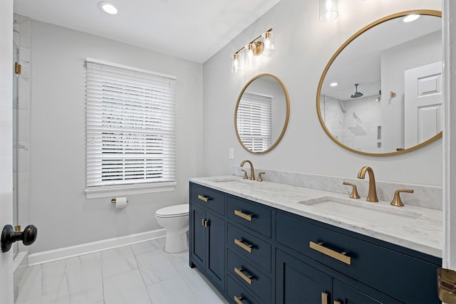 bathroom featuring vanity, walk in shower, and toilet