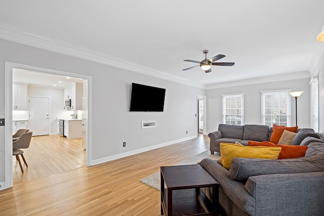 living room featuring crown molding, ceiling fan, and light wood-type flooring