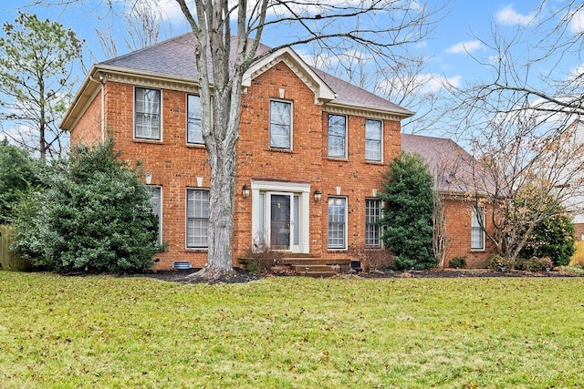 colonial-style house with a front yard