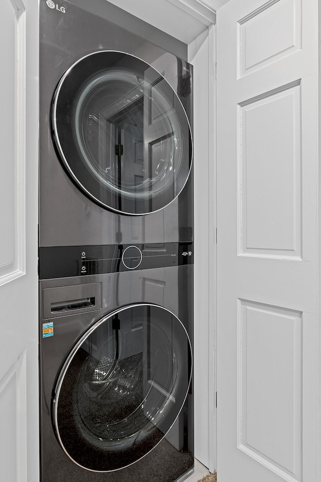 washroom with stacked washer and dryer