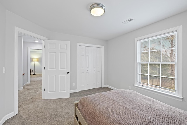 bedroom with carpet and a closet