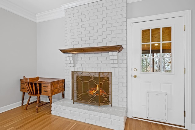 interior details with hardwood / wood-style floors, a fireplace, and ornamental molding