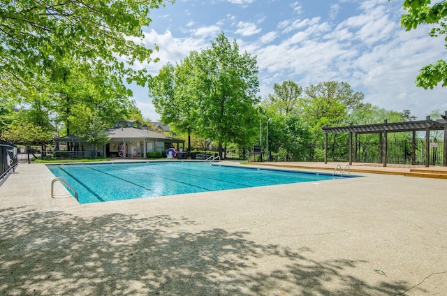 view of pool with a pergola and a patio area