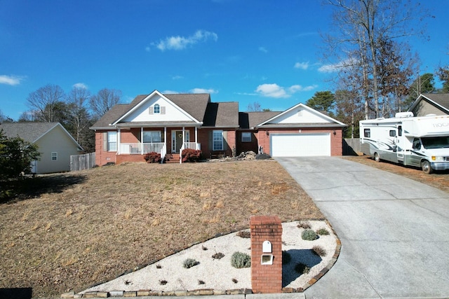 view of front of house featuring a garage, a front yard, and covered porch