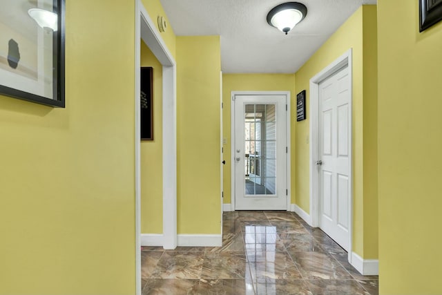 entryway with a textured ceiling