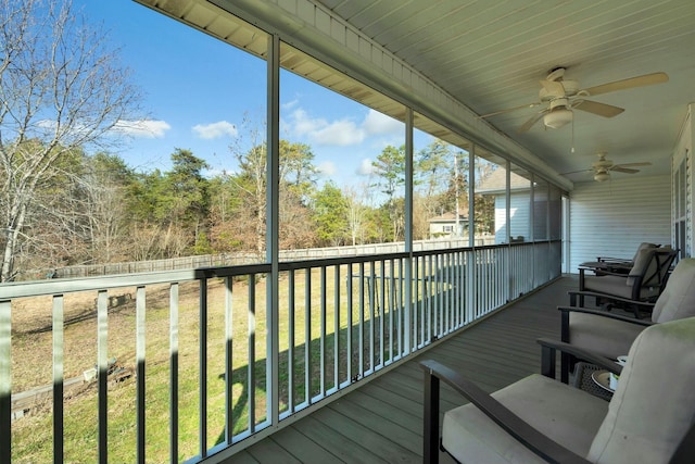 wooden deck with a lawn and ceiling fan